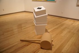 stacked boxes and huge mallet on gallery floor