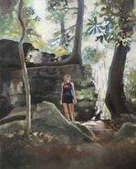 girl standing in forest in front of large rocks