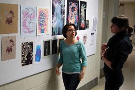 students viewing prints in hallway