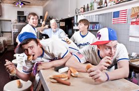 students posed in a diner eating hot dogs