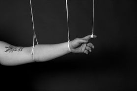 an arm being held up by string