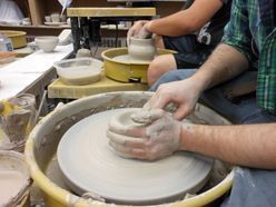 throwing clay on wheel