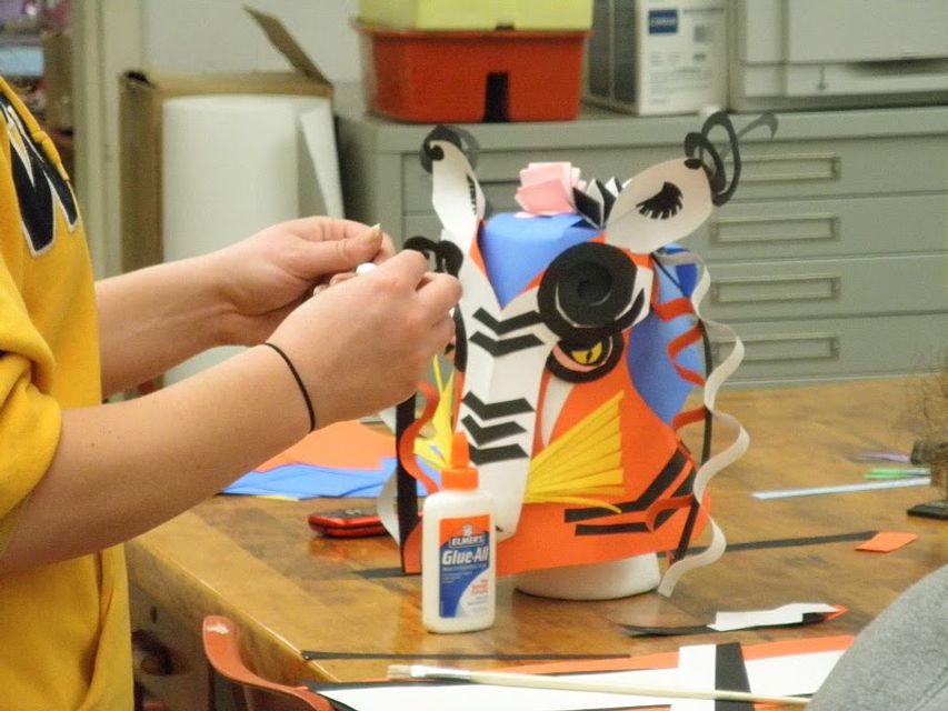 Student crafting an animal mask