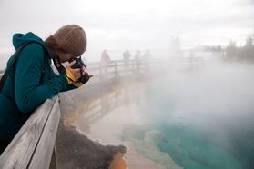 student taking photo of hot springs
