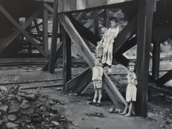 three children playing on a coal tipple