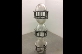 three stacked clear eggs with metal casings